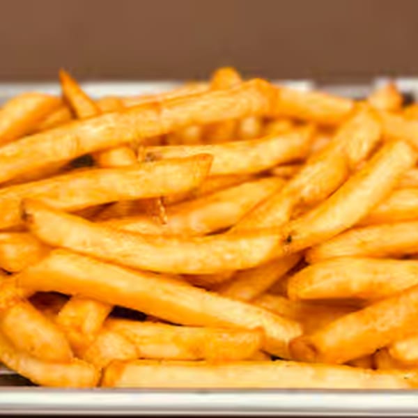 Close-up of a large serving of golden-brown french fries in a metal tray at Endzone Bar & Grill.