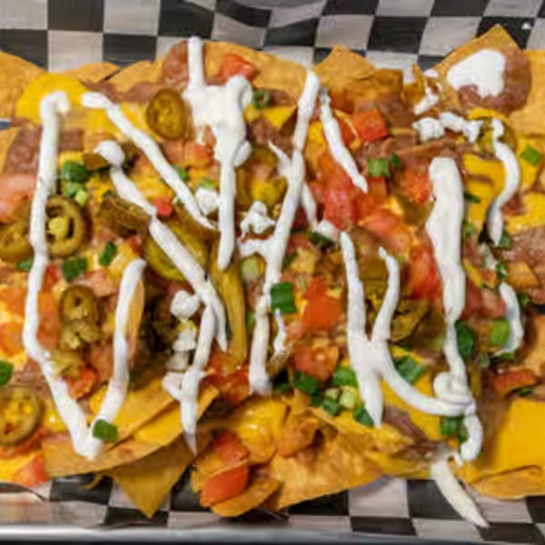 Endzone Bar & Grill's loaded nachos with cheese, jalapeños, tomatoes, and sour cream.